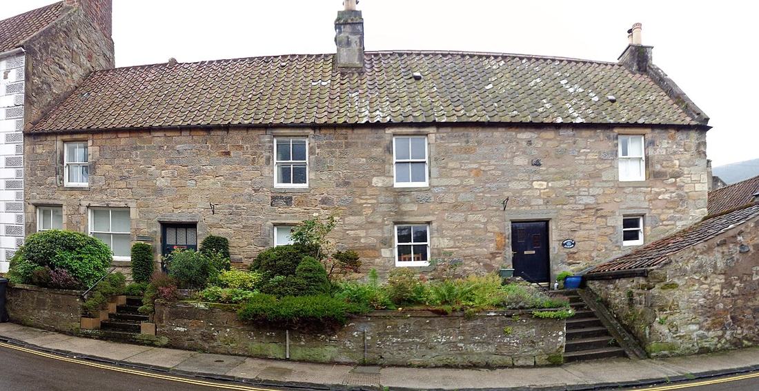 Two houses on a high street.